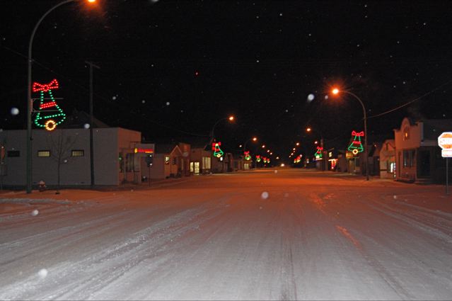 a small saskatchewan town street with christmas lights, on a cold winter night.